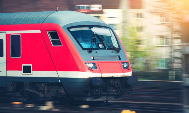 Train moving at speed along a rail line