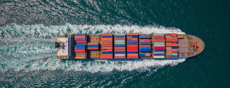 Container ship sailing at sea, seen from above